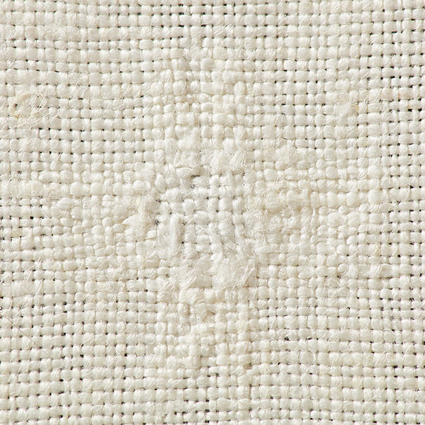 The invisible technique of linen darning is worked on the wrong side of the fabric by laying in a warp and weaving a plain-weave weft across. Photo by George Boe.