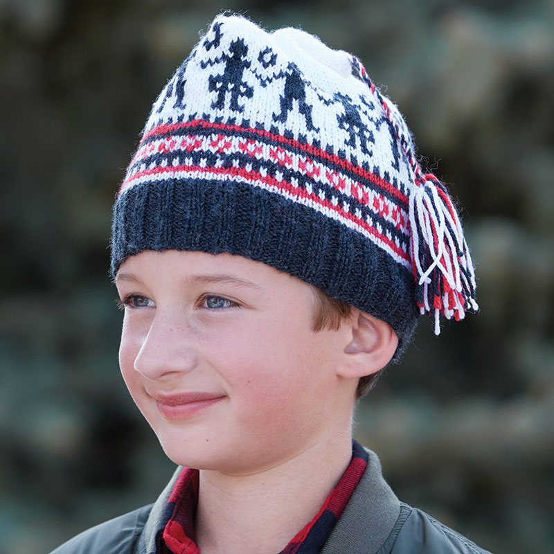 Susan Strawn’s knitted cap “Norwegian Barnelue to Knit” will delight the younger set. The dancing couple plus the stripes and tiny geometric patterns are traditional Norwegian motifs. Photograph by George Boe.