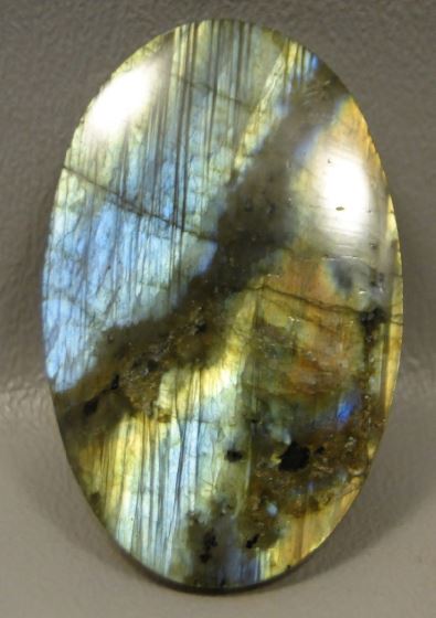 This oval labradorite cabochon shows a lovely pattern of color, but what makes it striking is the use of dark matrix on the diagonal. Photo courtesy Barlow’s Gems.