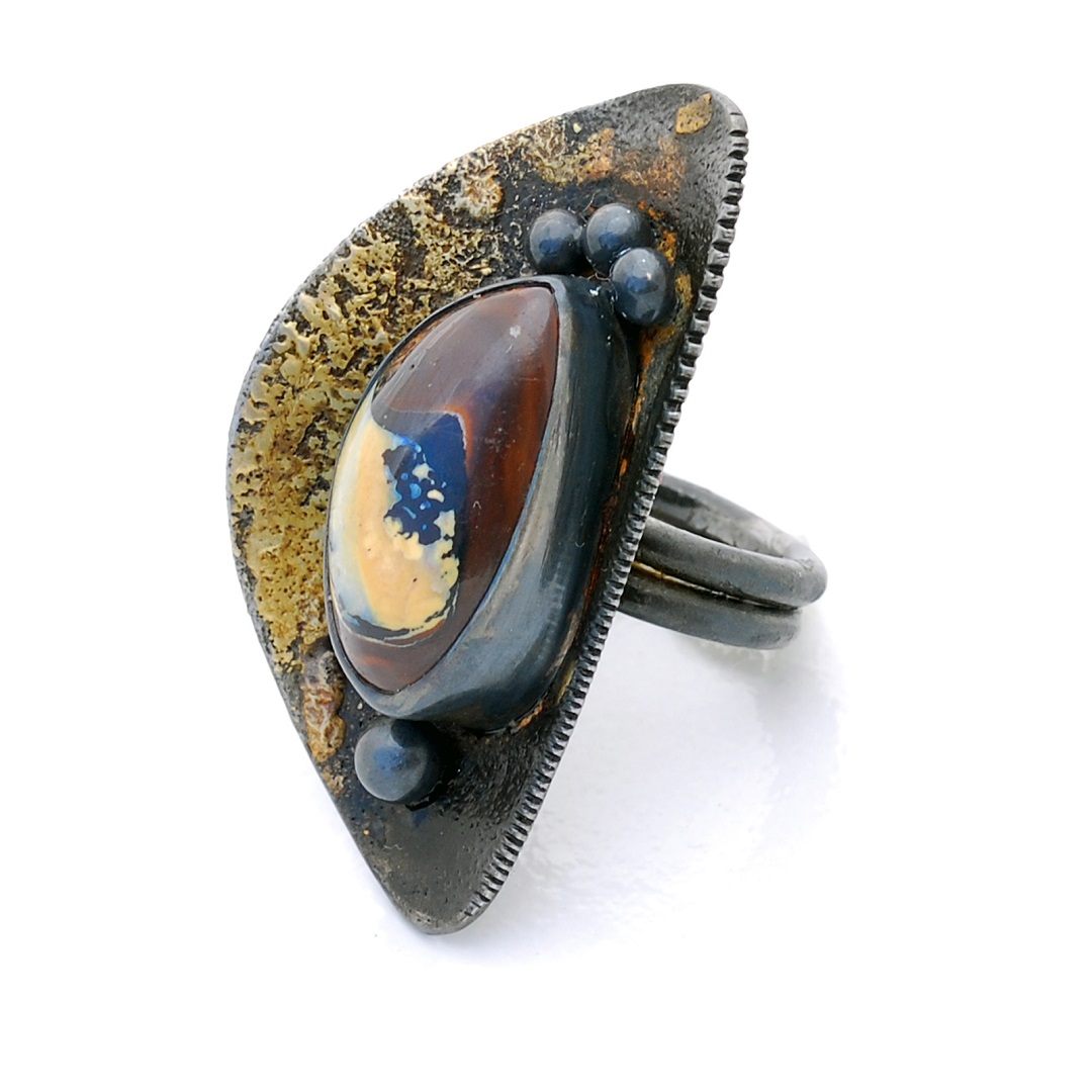 Darkened steel and fused gold in this ring by Bette Barnet cradle this freeform cabochon koroit opal. Photo courtesy Bette Barnett.