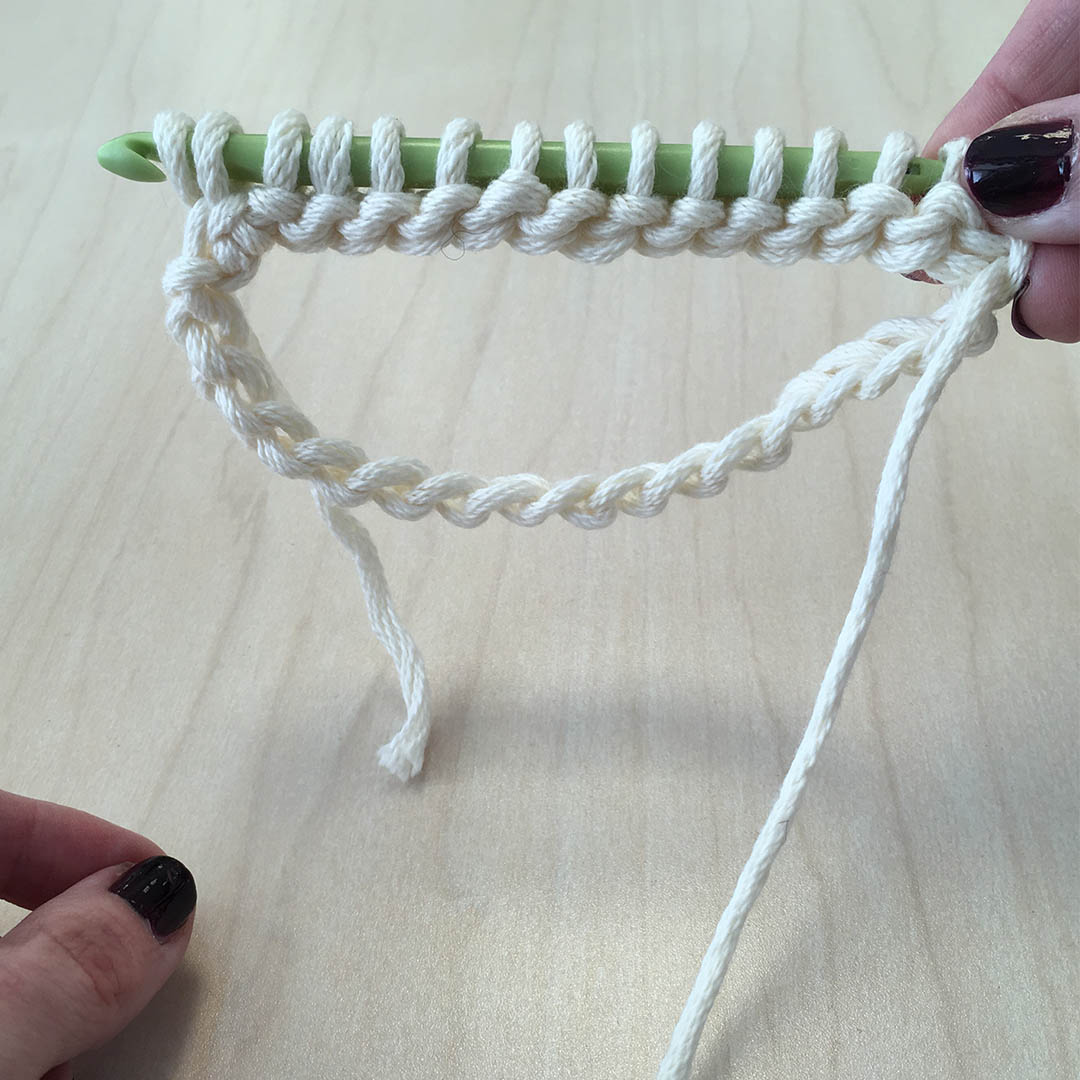 Once your hook feels crowded, flip your work so the wrong side is facing you and work off the opposite end of the hook. | Photo Credit: Sara Dudek