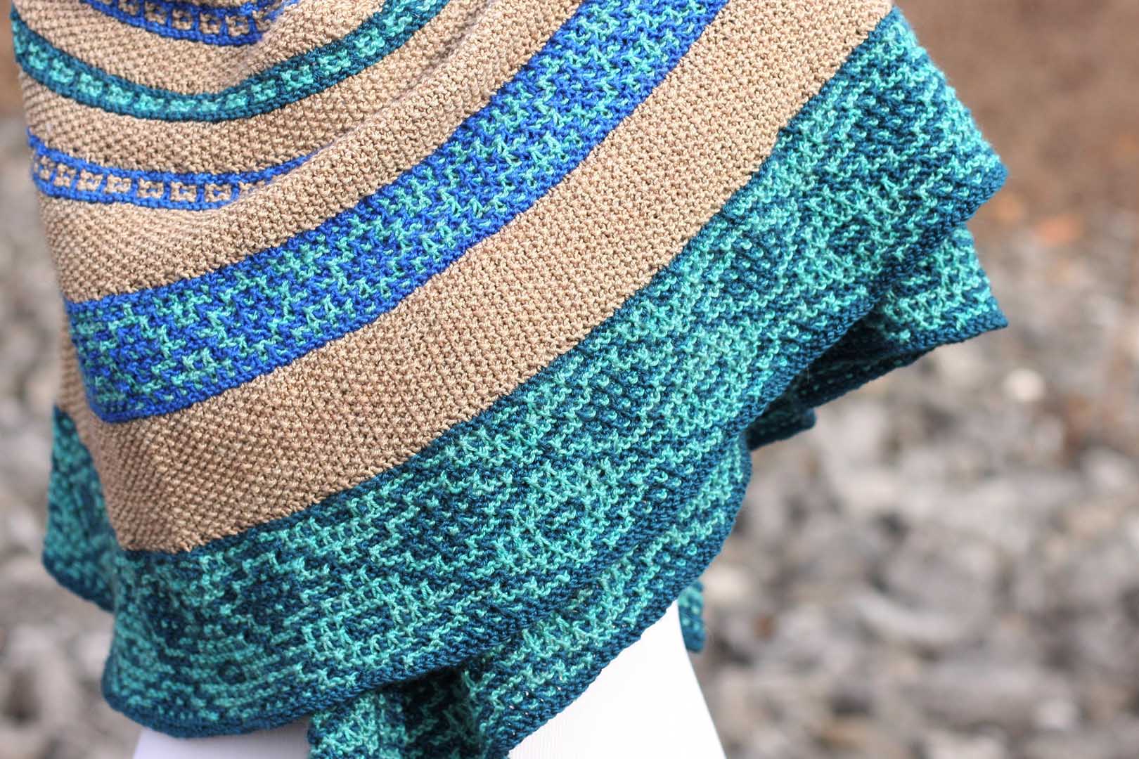 Simone’s educational background in art and languages is evident in Markanda, a mosaic slip-stitch shawl that reflects the beauty of the ancient bazaars along the Silk Road, a network of ancient trade routes that connected East Asia and Southeast Asia with East Africa, West Asia, and Southern Europe.