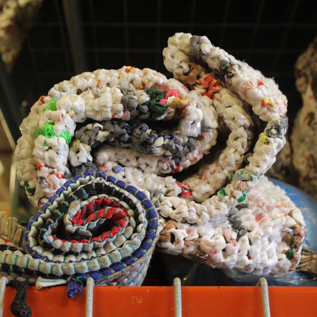 Unlike their traditional textile counterparts, plarn mats are weather resistant | Photo Credit: Shelene Codner