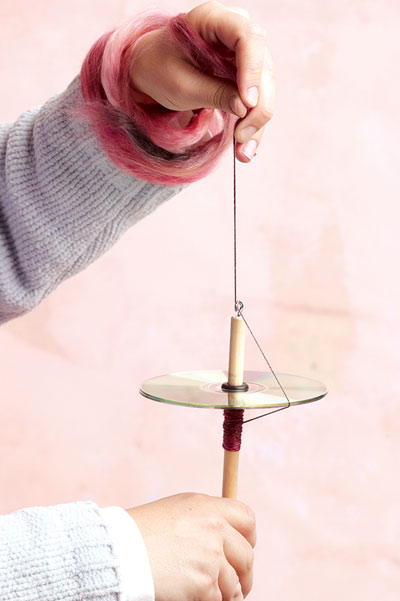 A DIY drop spindle made from a CD is an easy, portable, and inexpensive way to get a new spinner started.