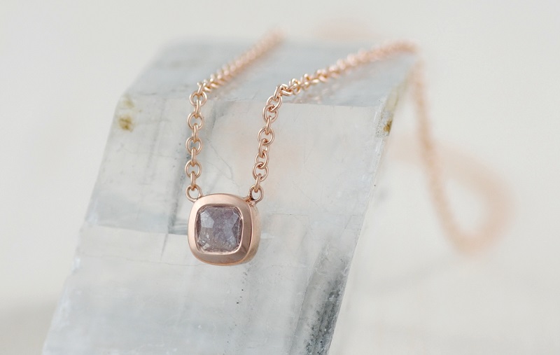 The imperfect perfection of wabi-sabi is seen in this 18k rose gold pendant by Michael Endlich. The grayish pink of the diamond is enhanced by the rose gold setting. The inclusions in the diamond, which make the stone almost opaque, make the stone and the pendant unique. Design by Michael Endlich, photo by Sarah Francis, courtesy Pavé Fine Jewelry.