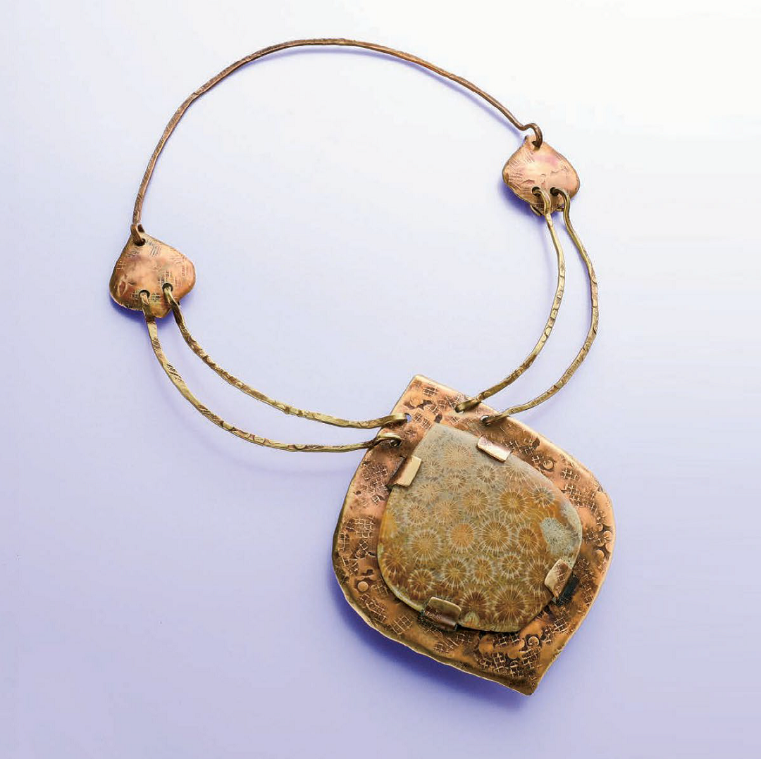 Linda Larsen’s Tabbed Fossil Coral Pendant, in a richly textured earthy palette, was originally published in Lapidary Journal Jewelry Artist, January/February 2012; photo: Jim Lawson