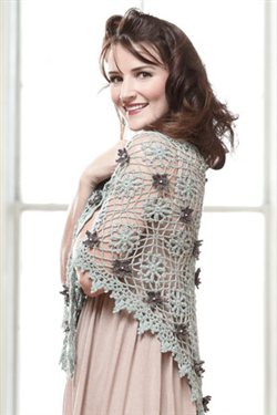 This gorgeous lace crochet shawl is embellished with crochet flowers.